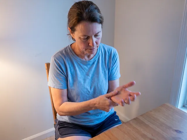 Person holding their wrist and forearm in discomfort