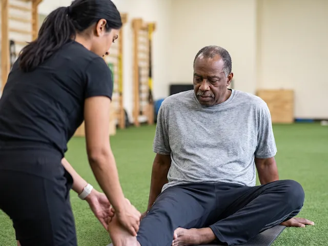 Hands stretching and checking a patient's foot
