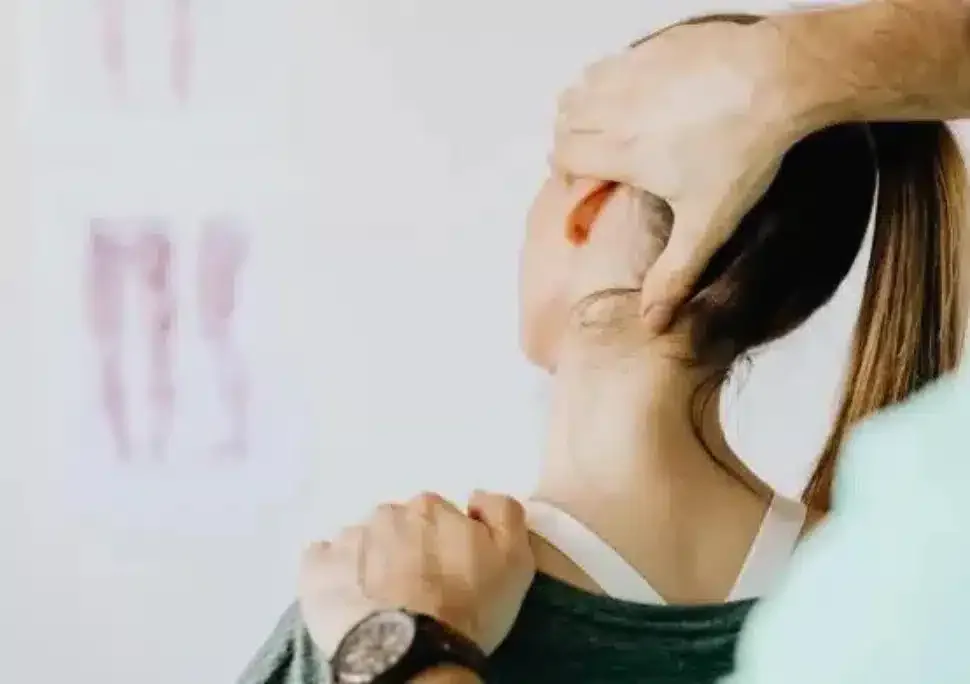 Physical therapist performing a hands-on cervical spine technique