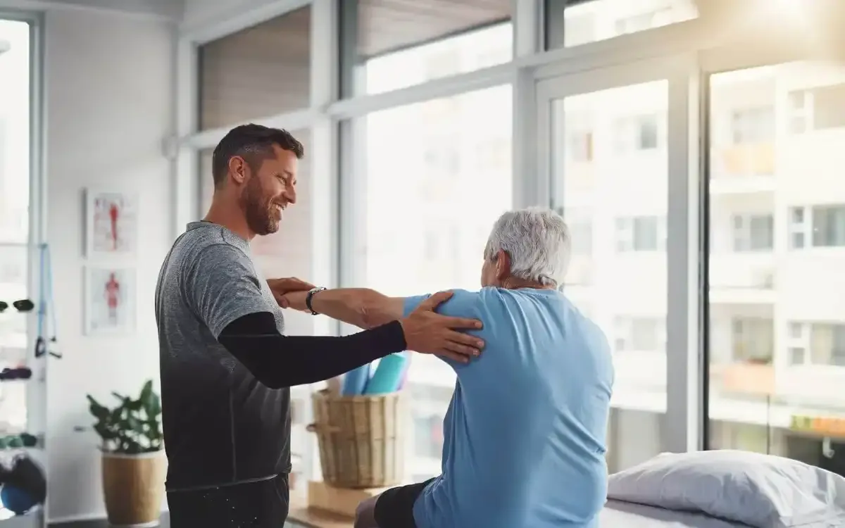Physical therapist guiding a patient through a hands-on treatment session
